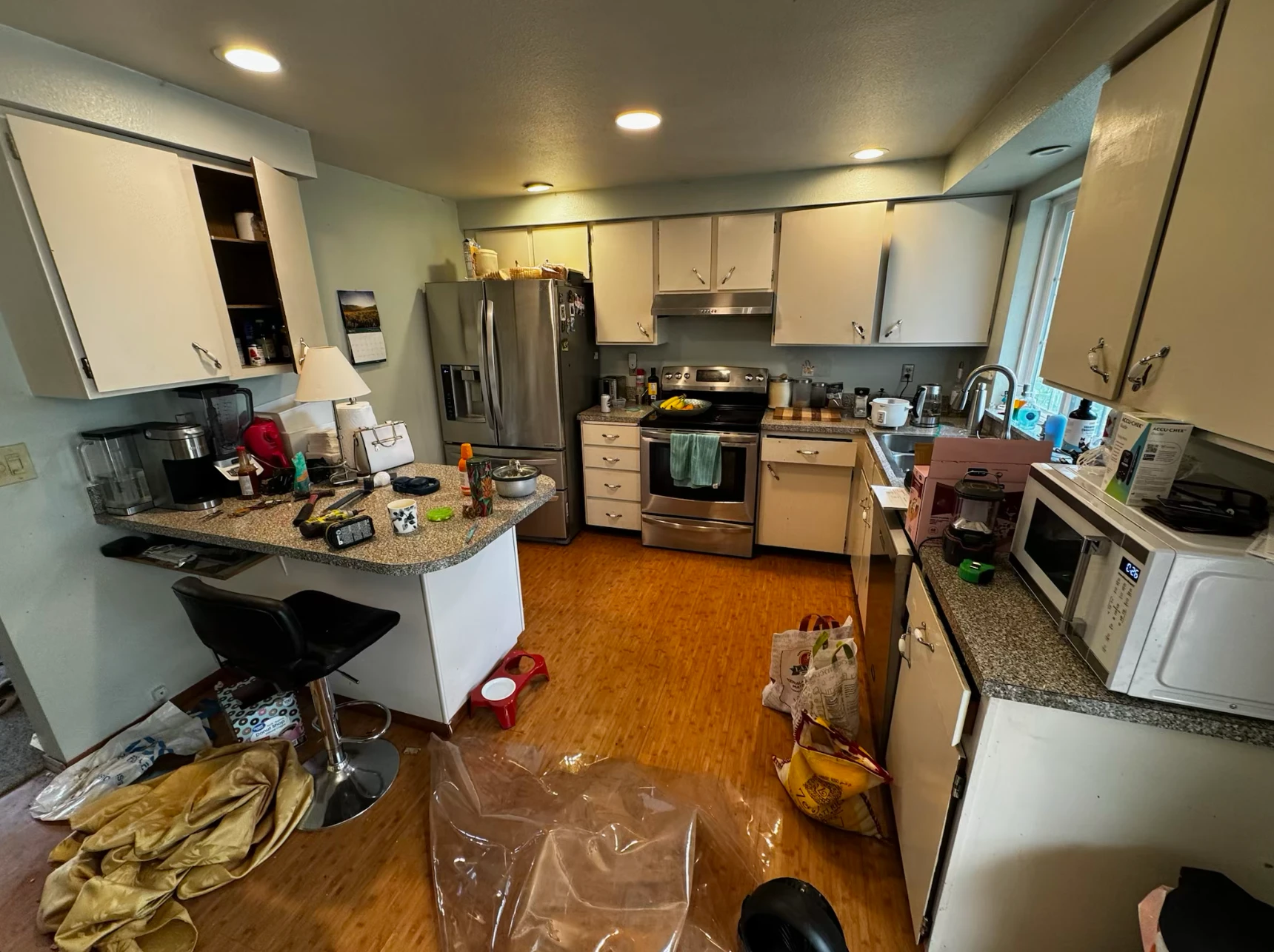 Cluttered dated kitchen before demolition